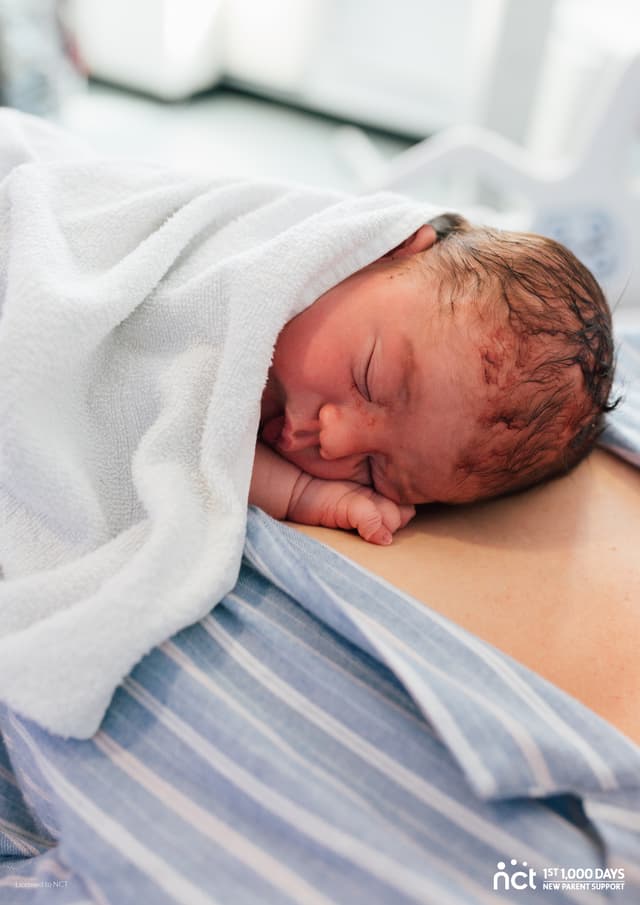 Baby sleeping on parents chest 
